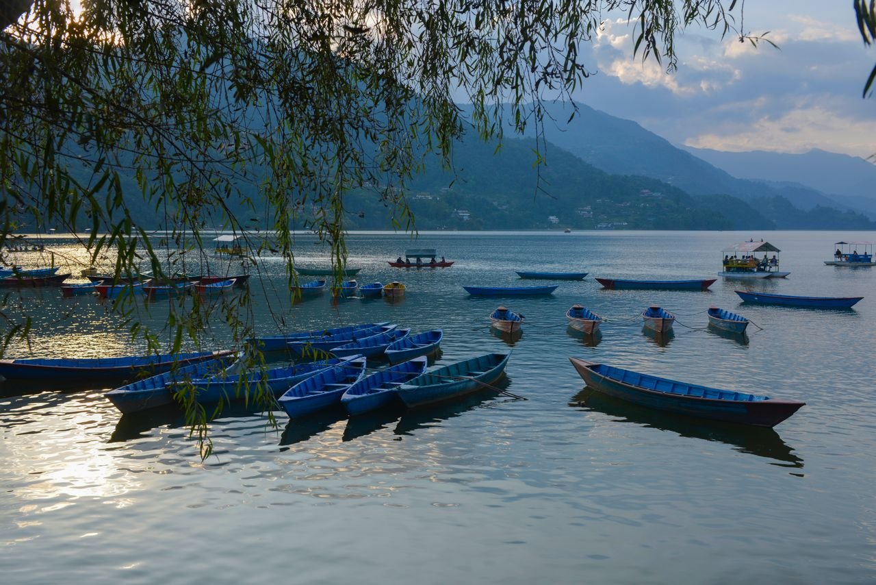 Pokhara landscape with boats and Himalayan mountains in Nepal